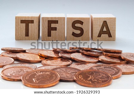 TFSA letters on wooden blocks with coins on a clear background