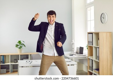 TGIF, Thank God It's Friday. Happy, Cheerful Office Worker Having Fun At The End Of His Workday. Funny, Crazy, Excited Man In A Suit Celebrating Promotion Or Payday, Dancing Gangnam Style And Jumping