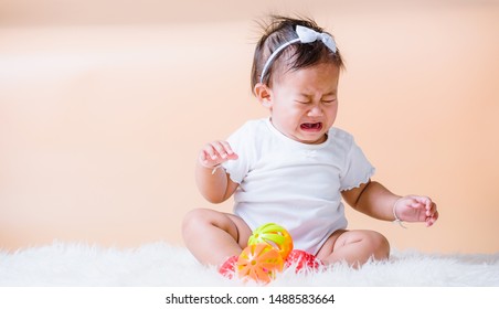 Thai Asian Child Baby Sitting And Sad Tantrum Her Cry Upset, Face Is Sadness Unhappy