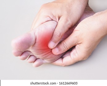Thai Asian people with foot pain and use hands to massage on sole feet to relieve, illnesses and health problems concept.
