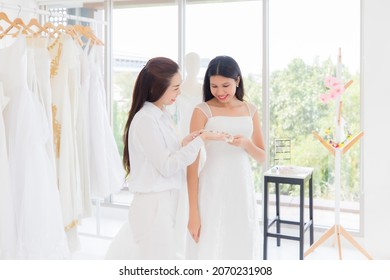 Thai Asian Woman Measuring Herself By Tailor In The Dressing Room.