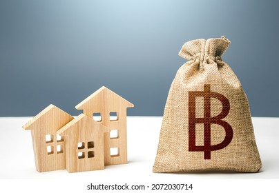 Thai baht money bag and residential buildings. City municipal budget. Mortgage loan. Costs of service and maintaining. Purchase of housing. Property tax. Investment in real estate.