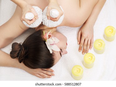 Thai Ball Massage. Woman getting SPA thai herbal compress massage. Top view