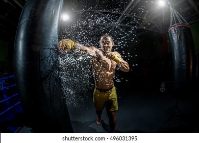 Thai Boxer Punch Hand By Punching Bag, Black Bacground, Horizontal Photo