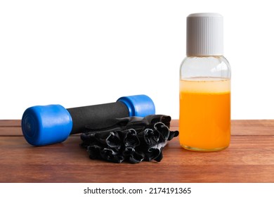 Thai Boxing Liniment (Namman Muay), Dumbbell and glove with clipping path on wooden table isolated on a white background. - Shutterstock ID 2174191365