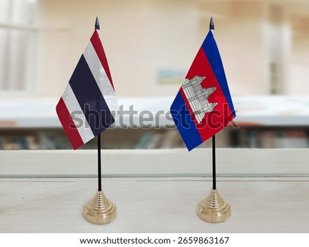 The Thai and Cambodian flags are placed on the table in the background of the meeting room. News background and background concept image. Double exposure hologram.