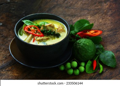 Thai chicken green curry with old wooden background