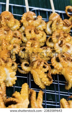 Thai cuisine. Grilled small octopuses