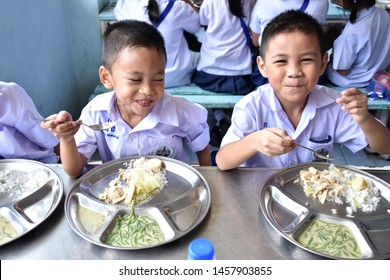 Thai Elementary School Students In School Uniform Are Enjoying Free Lunch From The Thai Government, Bangkok Thailand, July 2019