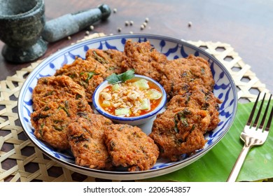 Thai fish cake or Fish cake ball - Thai food called Tod Mun Pla Krai with sweet chili dipping sauce  - Shutterstock ID 2206543857