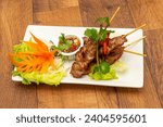 Thai food in bowls and plates including Thai starters, main courses, sides, rice and salads