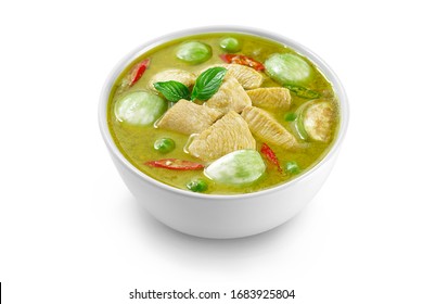 Thai food chicken green curry isolated on white background ,sliced chicken beast fillets, quartered eggplants, pea eggplant, basil leaves and pepper.