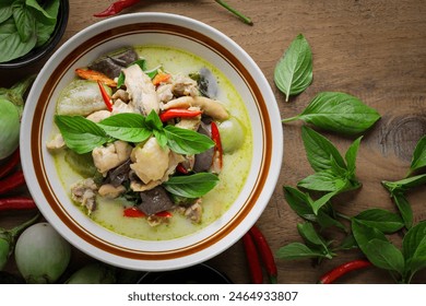 Thai food. Chicken green curry in a white bowl placed on a wooden table. Popular authentic Thai food concept. - Powered by Shutterstock