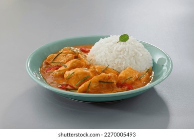 Thai food, Thai chicken red curry with stream rice (panang) in a green plate on grey background.Selective focus. - Powered by Shutterstock