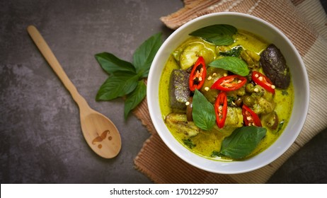 Thai food Green curry chicken top view on dark background.