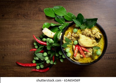 Thai food, green curry chicken with coconut curry on a wooden table. - Shutterstock ID 614654369