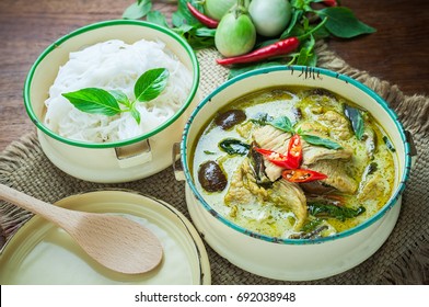 Thai food green curry chicken on wooden background. 
