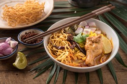 Thai Food, Khao Soi Kai, Thai Spicy Food, Thai Spicy Soup, Egg Noodle In Chicken Curry On Old Wooden Background.