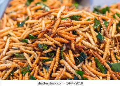 Thai food at market. Fried insects mealworms for snack