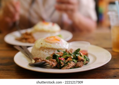 Thai Food : Pad Kaphrao Is Stirred And Fried Meat With Holy Basil And Chilies Served On Steamed Rice And Fried Egg. Shooting In Studio For Advertising. Thai And Asian Food Concept.