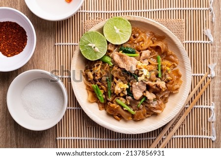 Thai food (Pad See Ew), Stir fried rice noodles with soy sauce, egg, kale and pork, Table top view