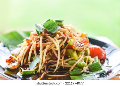 Thai Food, Papaya Salad On Black Plate, Close Up Papaya Salad Spicy With Yard Long Bean And Green Blur Background