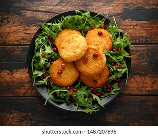 Thai Food Spicy Fish Cakes Served With Pomegranate Seeds And Wild Rocket, Arugula Salad.