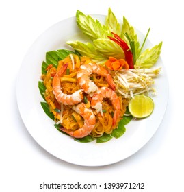 Thai food stir fried rice noodle with shrimp (Pad Thai goong sod ) and carved cucumber leaf. Thai cuisine delicious food The most popular of Thailand top view isolated on white background