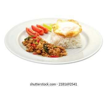 Thai Food Stir-Fried Chicken Spicy and Basil served with Rice ,Fried egg and tomato cucumber carved white plate side view isolated on white background