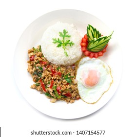 Thai Food Stir-fried Pork Spicy And Basil Served With Rice And Fried Egg And Tomato Cucumber Carved  White Plate  Top View Isolated On White Background