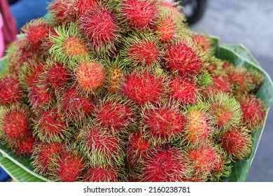 Thai fresh fruit rambutan,  a tropical fruit, The leathery skin of Rambutan is reddish, rarely yellow or orange is totally covered with flexible spines hairy-looking, colorful balls