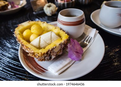 Thai Fruits And Dessert: Sliced Banana And Ball-shaped Mango Are Put Into A Pineapple Husk