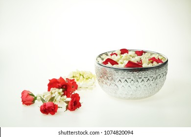 Thai garland Flowers and Water with jasmine and roses corolla in bowl isolated on white background (Use for Songkran festival in Thailand)