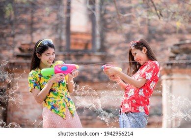 Thai Girl Smiling Asian Beauty Holding Plastic Water Gun Preserve The Good Culture Of Thai People During Songkran Festival. Thai New Year, Family Day In April