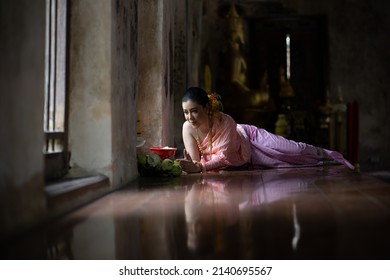 Thai girl with Thai Traditional costume in the old temple of Ayutthaya Thailand on Songkran or water festival.