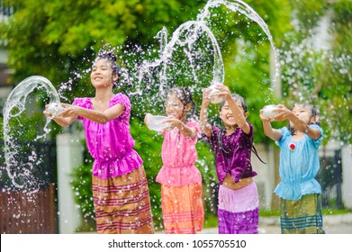 thai girls children playing water in songkran festival with thai period dress