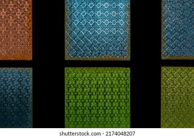 Thai green, blue and yellow patterned glass. Used to decorate the walls, doors. There are beautiful patterns. - Shutterstock ID 2174048207