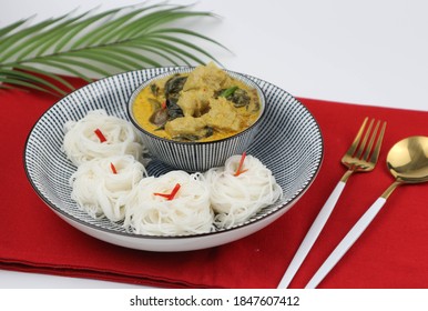 Thai green curry fish ball with fermented rice noodles on the wood table - Thai food called Kang Keow Whan on the red placemat