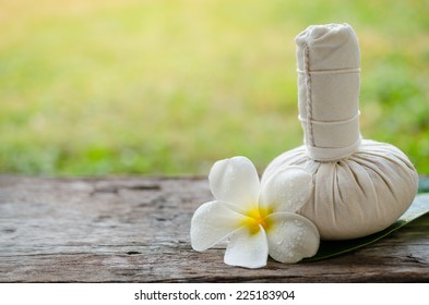 Thai herbal compress for spa with white plumeria flower (frangipani)