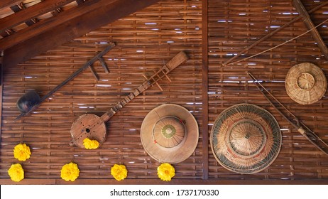Thai instrument and rattan hat on bamboo wall, Thai traditional decoration.