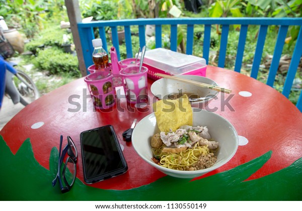 Thai local traditional street food dry noodles with\
pork called Kuay Teaw Ba Mee Hang isolated on withe background with\
clipping path.