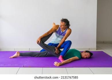 Thai Massage stretch for the quadriceps muscles (thigh and leg). Male massage therapist, female client.
