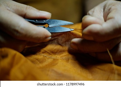 A Thai Monk Sewing A Robe For Kathina Ceremony.