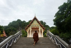 Thai Monk Walking Visit And Go To Respect Praying Buddha Statue At Wat Tham Khuha Sawan On October 4, 2017 In Phatthalung, Thailand