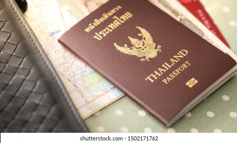 Thai Passport With City Guide Map, Some Banknotes Cash And Credit Card Lying On The Table. Travel Aboard, Get Ready, Preparing, Personal Identity. Asian Traveler, Thailand.