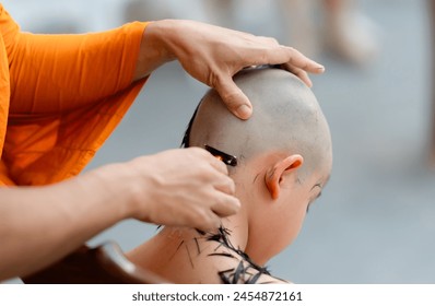 Thai people shave their hair and eyebrows with a razor and hold a light in preparation for ordination as a monk. - Powered by Shutterstock