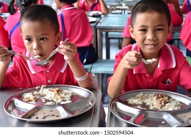 Thai Primary Students In School Uniform Are Enjoying Free Lunch From The Thai Government