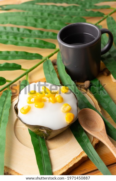 Thai Pudding Coconut top with corn, Desserts\
wrapped in banana leaves.Thai people call \