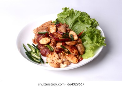Thai recipe , Spicy fried jackfruit seeds and chicken with roasted chile paste topped sliced sweet chili ,cashew nut and lettuce.