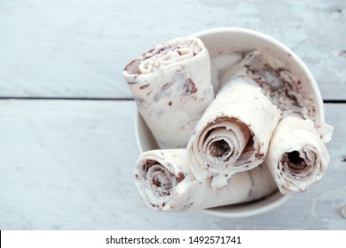 Thai Rolled Ice Cream On Light Blue Wooden Table With Copy Space